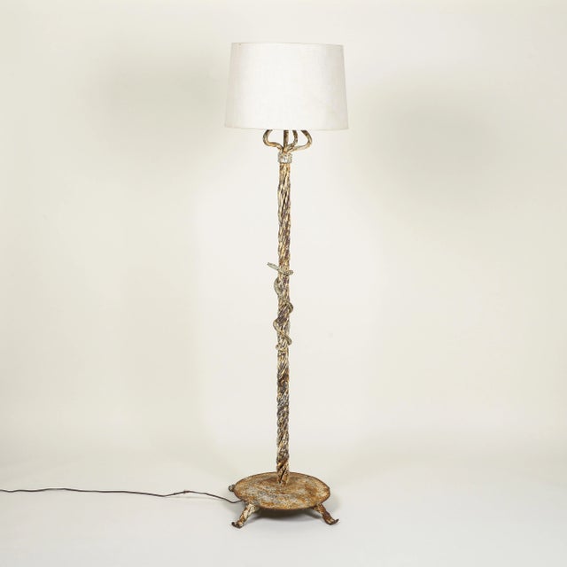 Of columnar form comprised of intertwined strands and fancifully wrapped with an asp; on a round plinth base and...