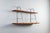 This vintage wall shelf is a beautifully restrained piece that combines solid oak with a minimalist bent metal frame....