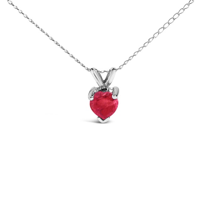 Evoke the essence of eternal elegance with this captivating pendant necklace, featuring a heart-shaped ruby, a symbol of...