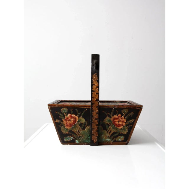 This is an antique Chinese box. The hand-painted black wooden box features lush pink flowers with a raised design. The box...