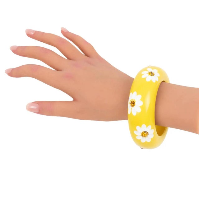 This exquisite lucite or resin bracelet bangle features a heavily domed, massive shape in a bright yellow color. The...