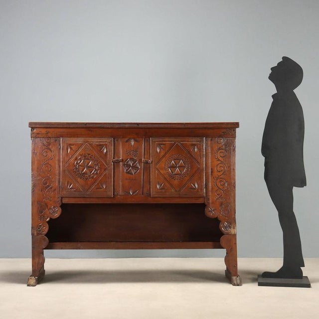 Sideboard crafted from walnut and chestnut, originating from early 19th century Spain. The front features a pair of doors...