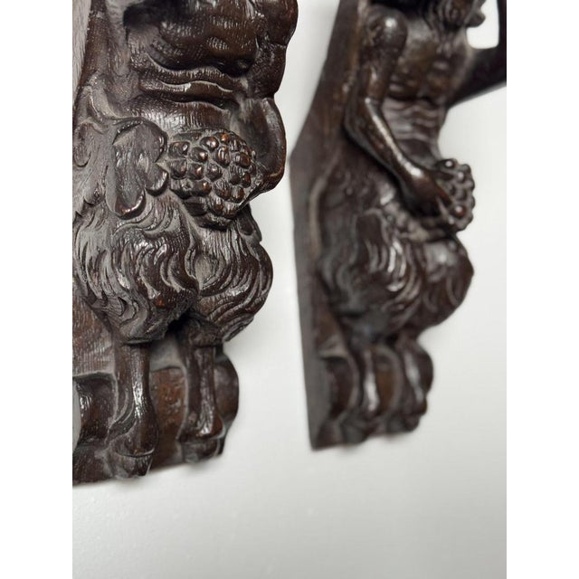 2 Hand-carved wooden statues / wall ornaments from Satyr. 17th or 18th century. Country of origin unknown. In Greek...