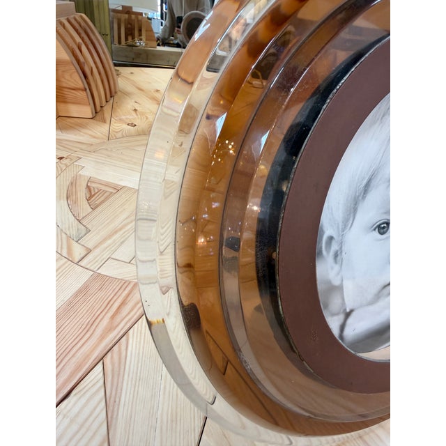 Elegant Italian picture frame dating from the 1970s, featuring a substantial circular Lucite body with softly rounded...