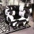 Pony Bibendum Armchair black and white, covered with treated natural cowhide, on polished stainless steel base....