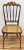 Vintage wood Chiavari style chair featuring carved spindle back and legs with caned seat. This would make a stunning...