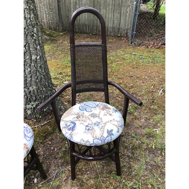 Gorgeous pair of vintage Collins rattan side chairs, one with arms, one without. Newly upholstered in a fabulous...