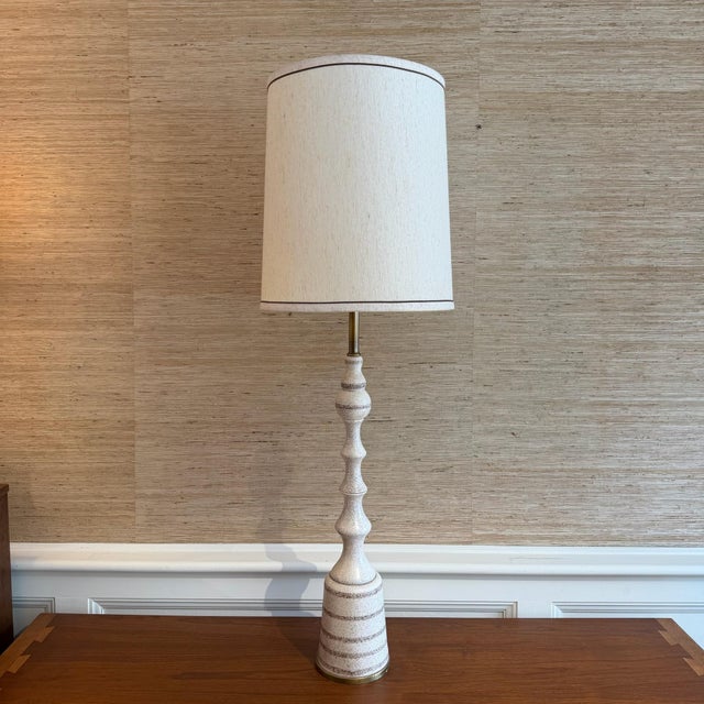 Mid-century modern ceramic and brass table lamp with original shade and milk glass diffuser. The ceramic body has a really...