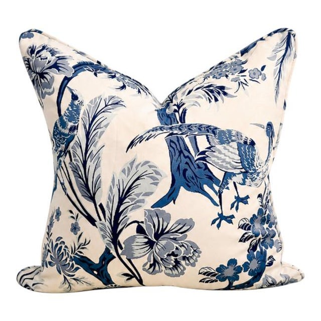 A beautifully tailored of chinoiserie-style accent pillow featuring an elegant bird and floral motif in layered blue tones...