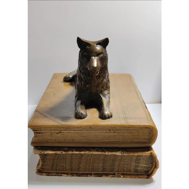 For your consideration . . . A vintage bronze sculpture design of a wolf lying on the top of a faux leather book. The...