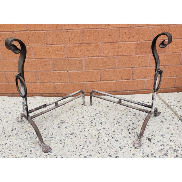 Pair of 19th Century Hand Forged Iron Andirons. Meaures 12" in width, 14" in depth and stand 18" tall.