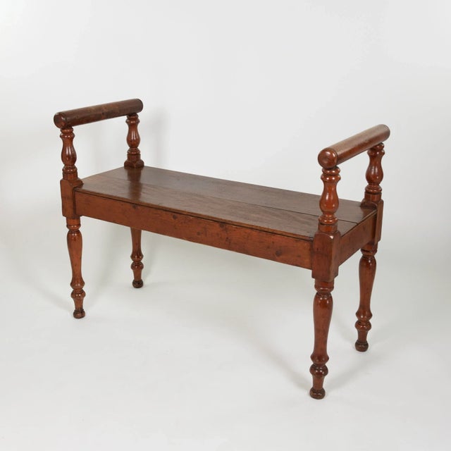 A late Victorian mahogany window bench with raised arms and elegantly turned legs. height: 27 in. (69 cm) width: 36 in....