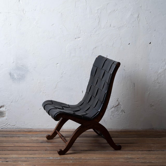 A Pierre Lottier woven leather lounge chair with an oak frame and nailhead trim, from Spain, 1960s. 18 inches wide by 23 ¼...