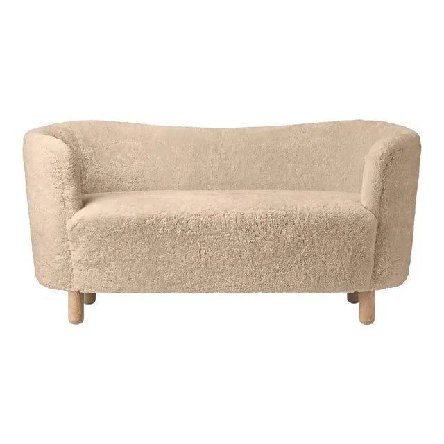 Honey Sheepskin and Natural Oak Mingle Sofa by Lassen Dimensions: W 154 x D 68 x H 74 cm Materials: Sheepskin, Oak. The...