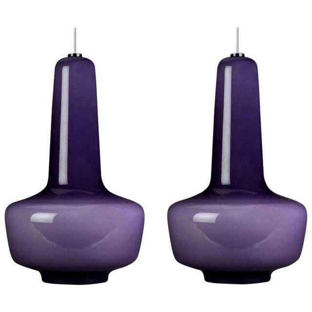 Pair of modernist wall lamps in beautiful warm purple-colored glass. with lovely steel or transparent cable for a clean...