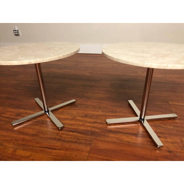 Pair of vintage side tables featuring travertine tops with stainless steel bases, manufactured by Helikon Furniture Circa...