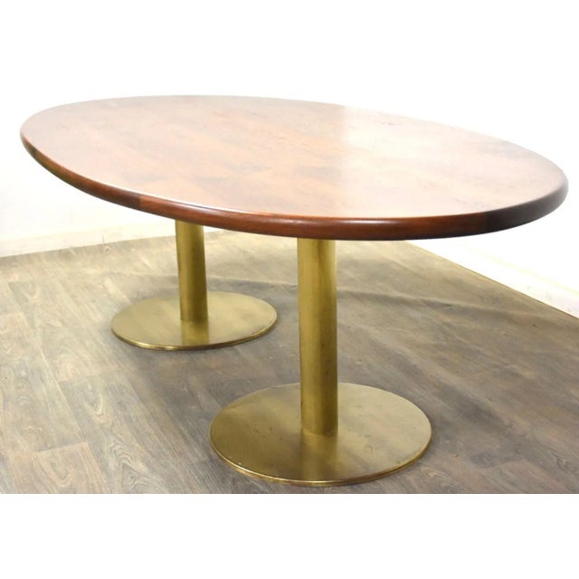 A mid century modern walnut top dining or conference table with brass pedestal bases. Perfect for an office or home...