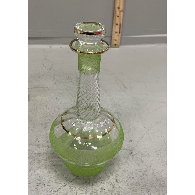 DESCRIPTION An elegant mid-century five-piece cordial service, circa 1950s–1960s, featuring a sculptural glass decanter...