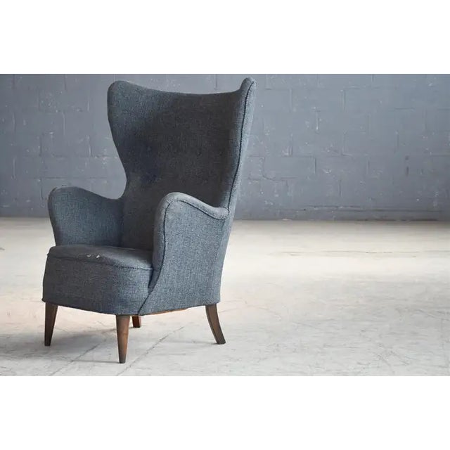 Very stylish Danish wingback lounge chair from circa 1950. We love the organic slim profile of the design reminiscent of...