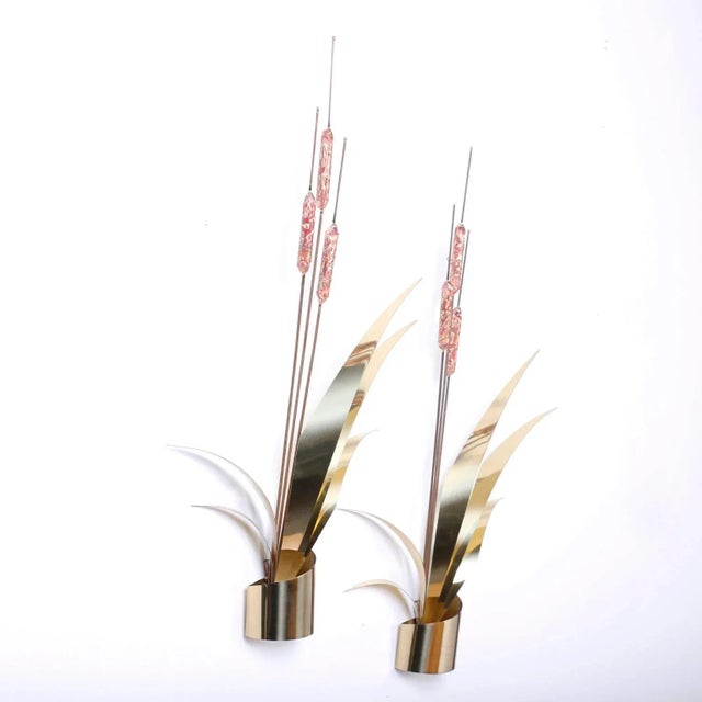 Swank pair of wall sculptures crafted in copper and brass in the form of stylized cattails or Typha. Hand polished and...