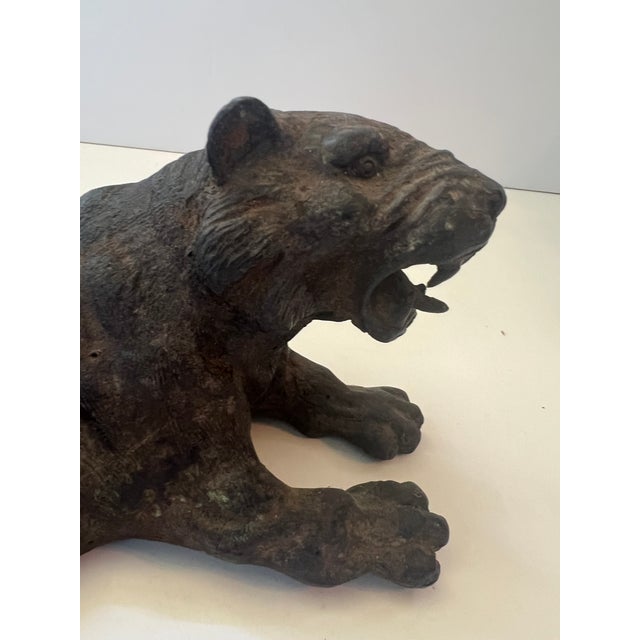 Vintage dark, metal or bronze colored tiger sculpture. Hand carved spelter roaring tiger with fierce expression. bronze...