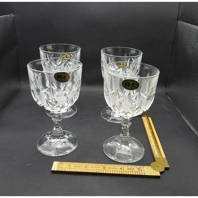 This marvelous set of 4 vintage 1950s wine stem glasses are created in gorgeous hand-made cut-glass crystal with acid...