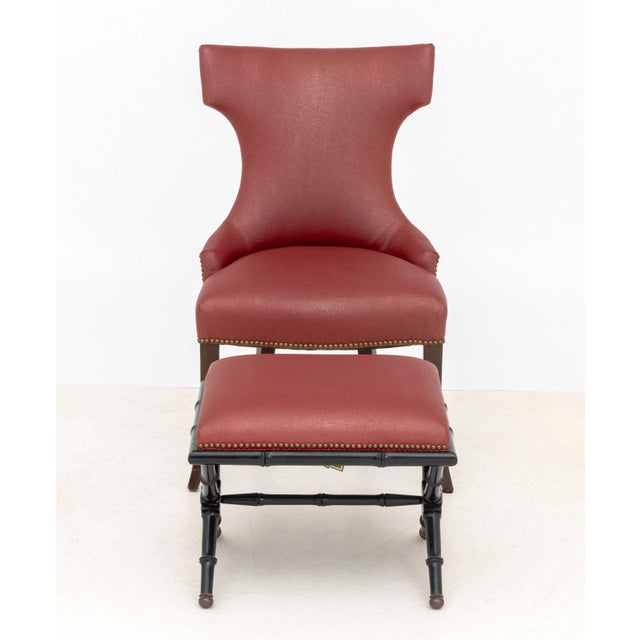 Contemporary Red Upholstered Lounge Chair and Ottoman, the chair with riveted design on four mahogany legs and ottoman...