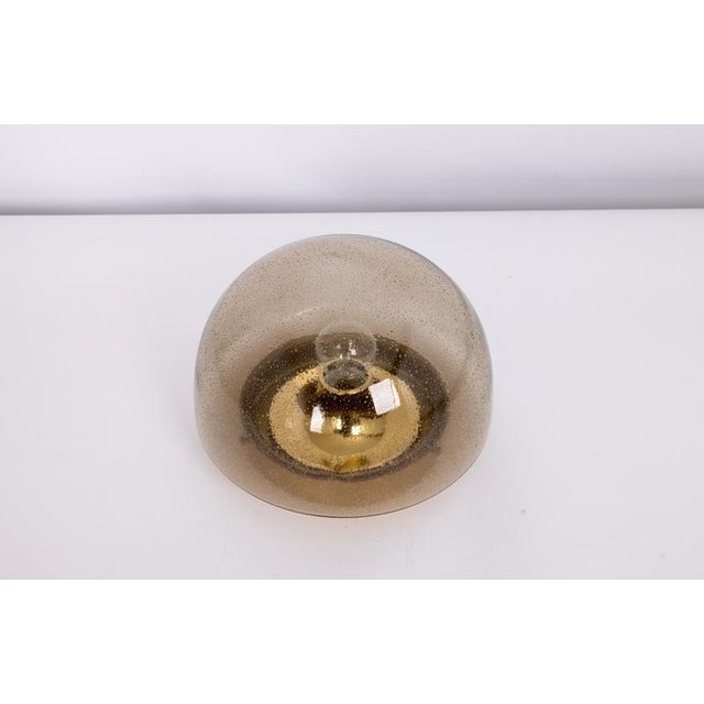 One of four round glass flush-mount ceiling lights by limburg, germany, 1970s. Featuring hand-blown smoked glass with an...