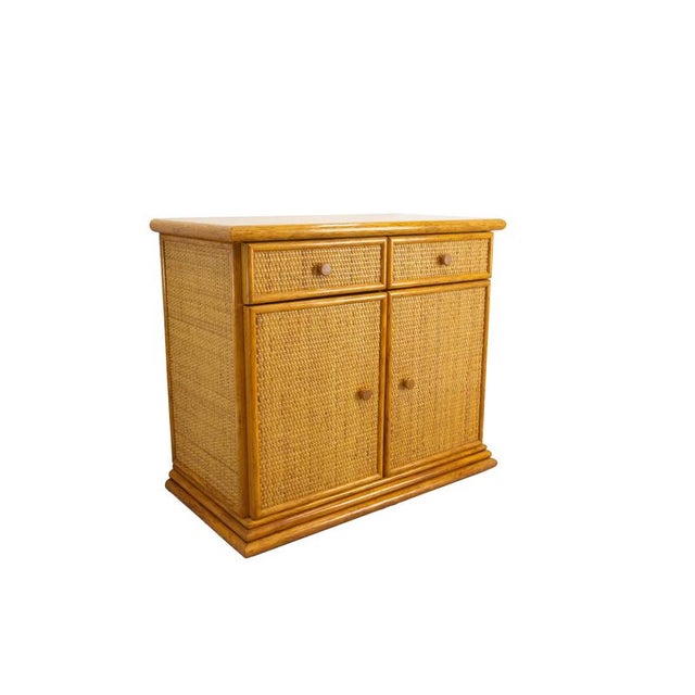 French rattan and elm credenza buffet. Two doors and two drawers. Typical design of the 1970's, this side cabinet has been...
