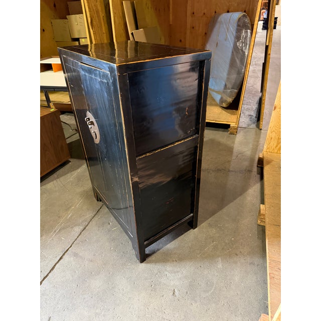 A traditional Chinese wooden lacquer cabinet crafted in a rich black lacquer finish with intentional patina. Traditional...