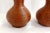 - Pair of soliflore vases - High flared neck body on spheric - Made of matte terracotta - Black and orange-red speckled on...