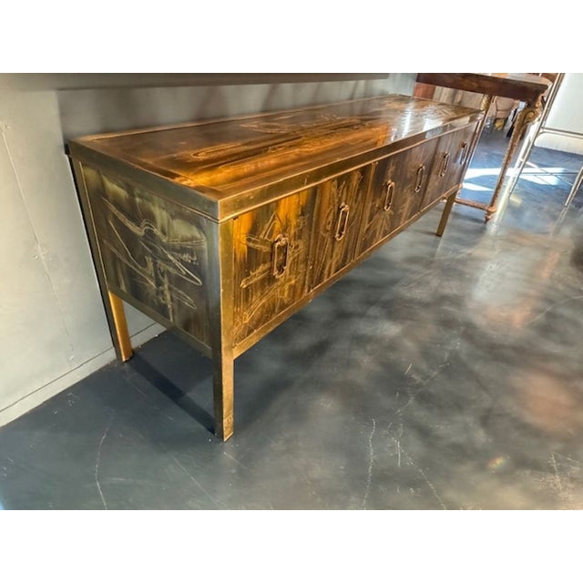 Bernard Rohne for Mastercraft acid etched brass credenza. A Bernard Rohne for Mastercraft acid‑etched brass credenza is...
