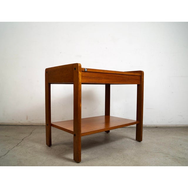Vintage Mid century Modern teak night stand for sale. It was manufactured by Bif in the 1970's, and has a clean design. It...