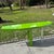 A vibrant Postmodern console table showcasing a striking high-gloss lime green laminate finish. The elongated geometric...