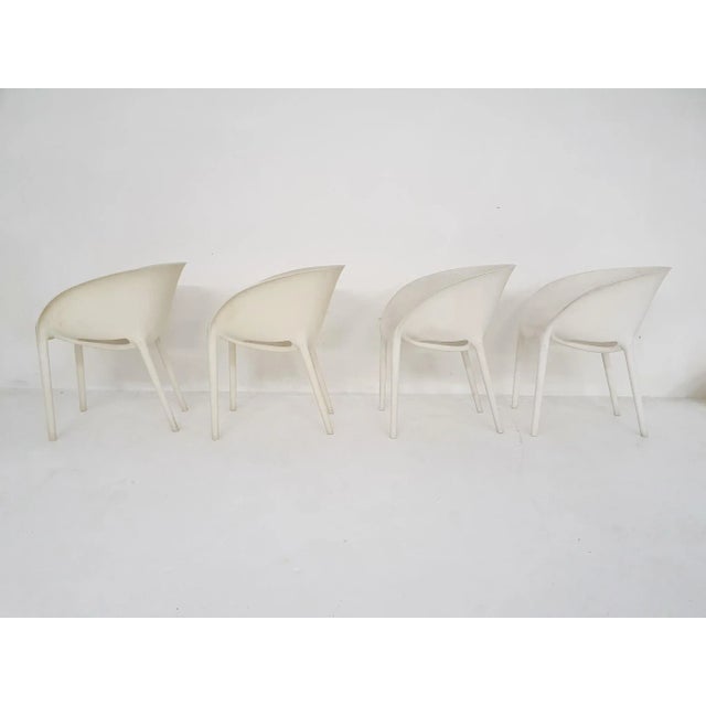 Four white plastic outdoor stackable dining chairs. The chairs were used outside, and are a bit dis-coloured Phillippe...