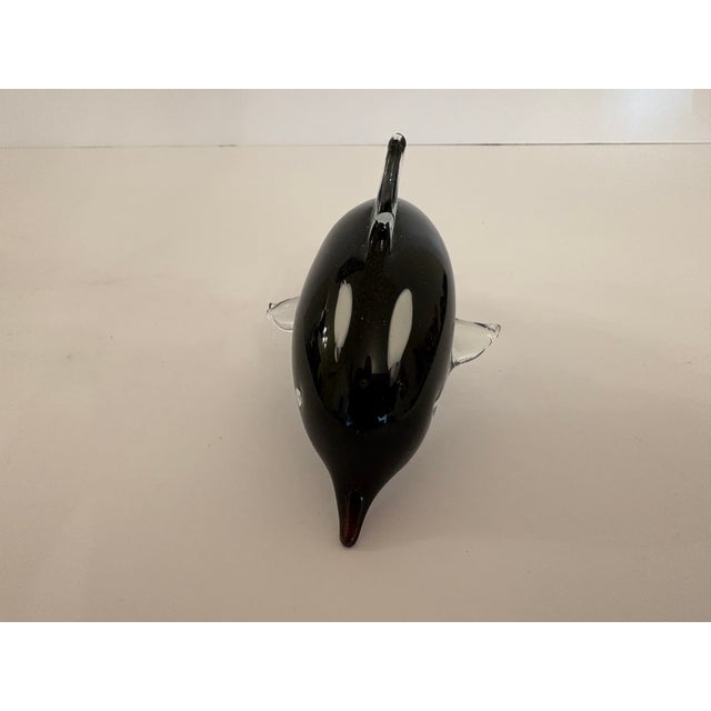 This Murano hand blown glass vintage Orca is black, white and transparent standing 3 and 1/2 inches tall by 3 inches wide...