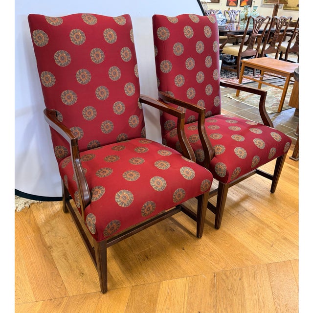 A stunning pair of Ethan Allen armchairs feature solid mahogany frames with a graceful curved arm profile and square...