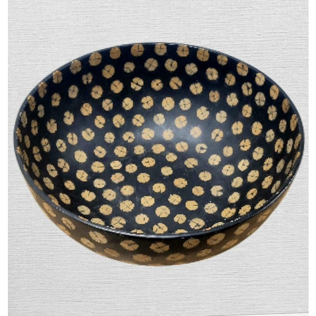 An oversized extremely large hand carved wood and coconut shell dotted decorative bowl. This is a wonderful decorative...