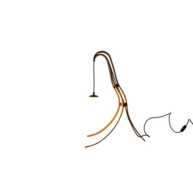 This one-of-a-kind floor lamp pairs a frosted glass globe with a handcrafted wooden arch of american nut, creating a...