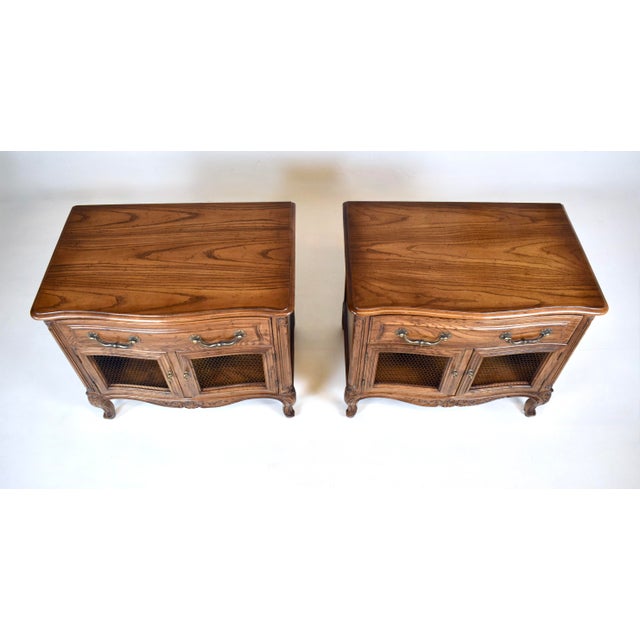 A pair of Henredon " Four Centuries " carved Oak Serpentine front nightstands with single drawer, cabinet beneath boasting...