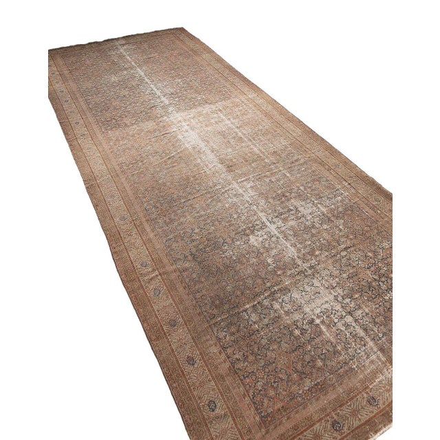 Vintage bring unparalleled soul and character to your space with this magnificent distressed vintage Persian Malayer...