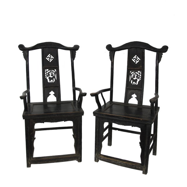 This pair antique Chinese high yoke back armchairs has a back splat adorn with nicely carved Buddhism symbol for peace and...