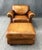 This brown leather club chair and matching ottoman feature rich, warm-toned leather upholstery with classic rolled arms...