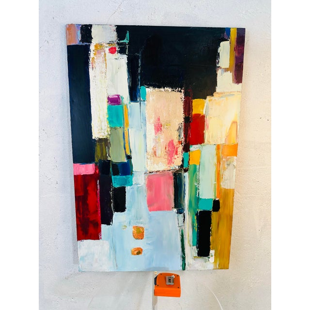 This is a bold and vibrant abstract painting, full of layered color and geometric movement. • The canvas is dominated by...