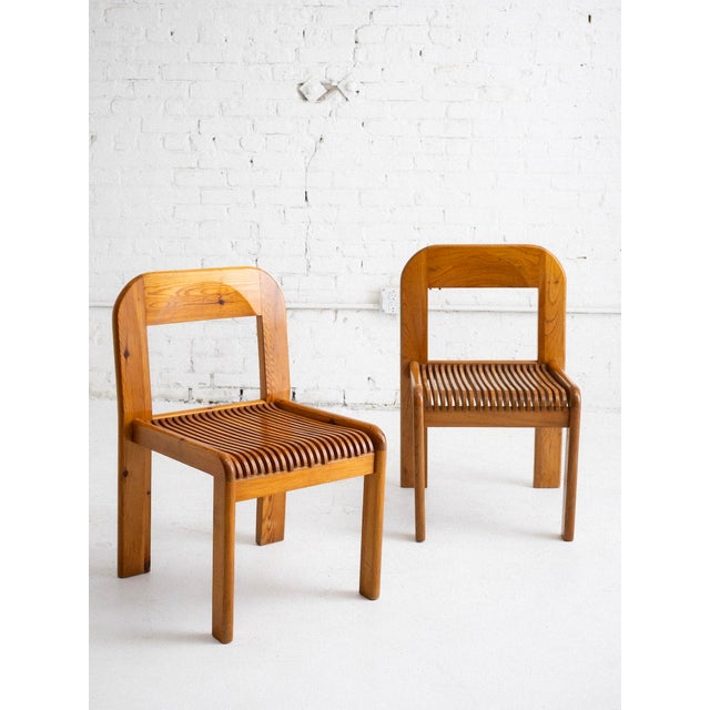 A set of 4 Post Modern Italian dining chairs constructed of solid pine. Seats are made of individual wood slats. Sources...