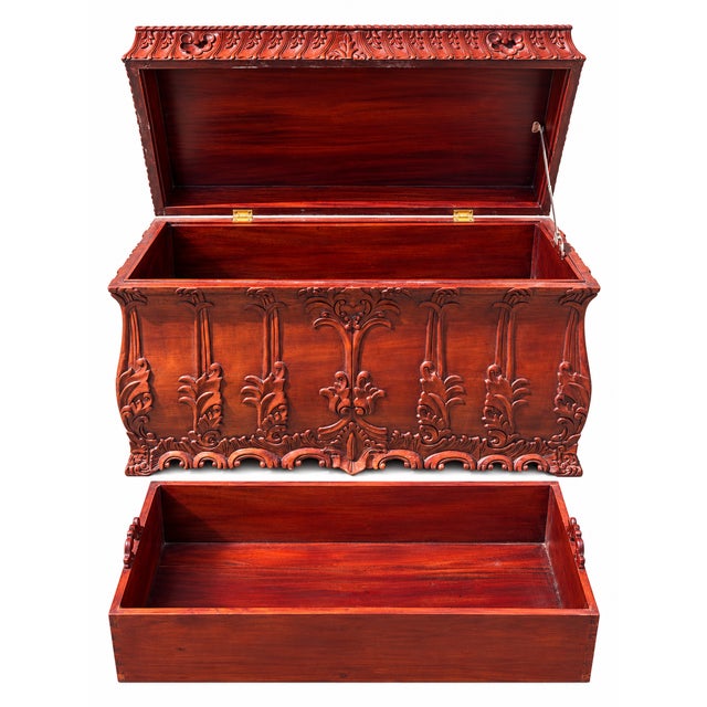 Likely Indonesian, this early-to-mid 20th century carved wood chest features exquisite, deeply sculpted floral and foliate...
