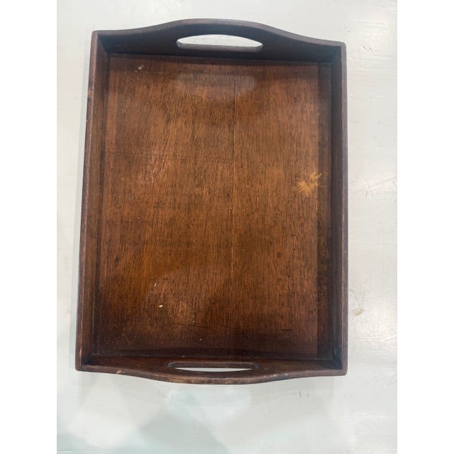 This beautiful vintage wooden serving tray features a rich, warm wood tone with gracefully curved handles for both style...