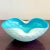 This hand-blown art glass bowl is a playful study in contrast and flow. With its icy white exterior and vivid aqua...