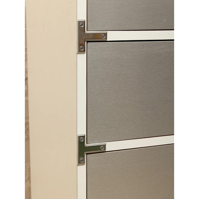A striking tall dresser with a distinctly Mod, Space Age-inspired look. The streamlined gray panels are framed by...