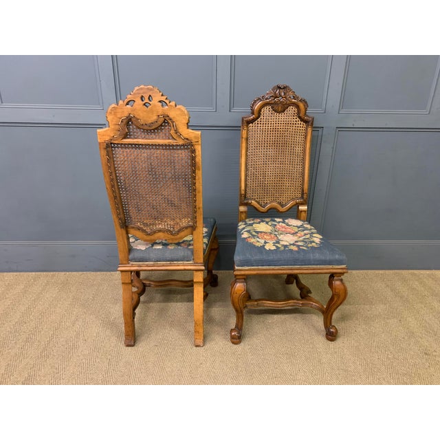 walnut and dating to the Edwardian period. with high backs fitted with their original cane work. The upholstered seats...